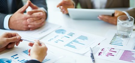 close-up-businesspeople-working-with-documents-scaled
