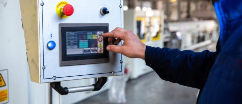 worker uses control panel in factory